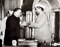 Dr. B R Ambetkar presenting the Constitution to Dr. Babu Rajendraprasad.
